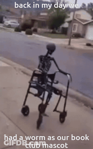 A Skeleton In A Walker With The Words Back In My Day We Had A Worm As Our Book Club Mascot GIF