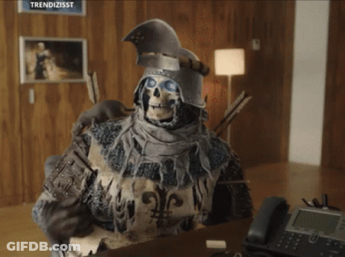A Skeleton In Armor Is Sitting At A Desk With A Telephone GIF