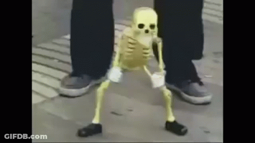 A Skeleton Is Dancing On The Sidewalk Next To A Person 'S Legs . GIF