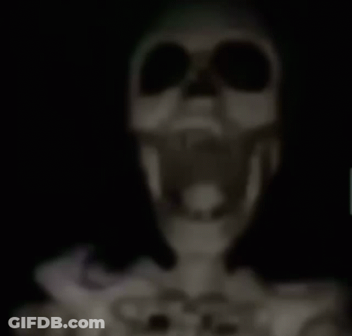 A Skeleton Is Hanging From The Ceiling With A Knife Sticking Out Of Its Head . GIF