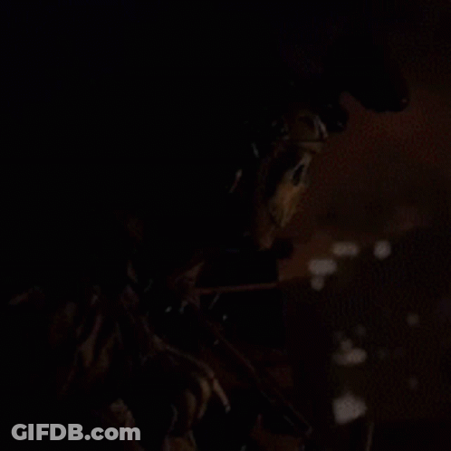 A Skeleton Is Holding A Gun In A Dark Area GIF
