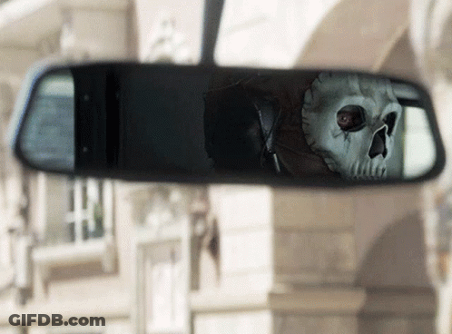 A Skeleton Is Reflected In A Rear View Mirror GIF