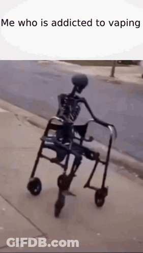 A Skeleton Is Riding A Walker On A Sidewalk . GIF