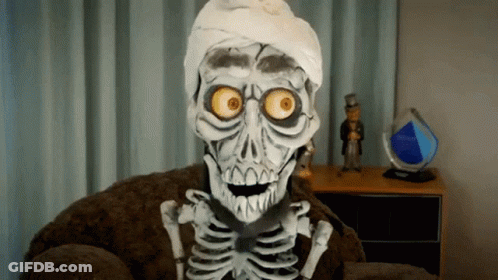 A Skeleton Is Sitting In A Chair With A Bandaged Head GIF