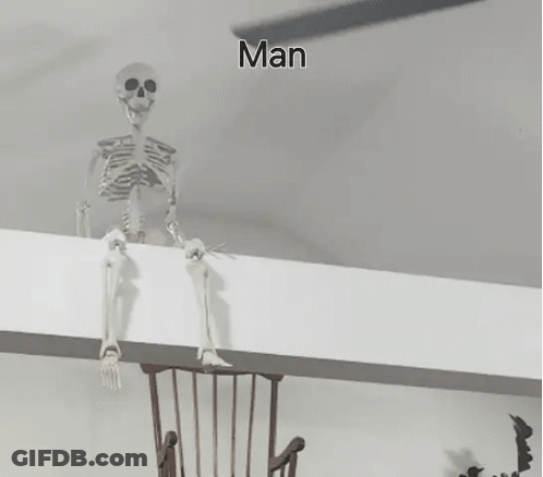 A Skeleton Is Sitting On A Wall Next To A Wooden Chair . GIF