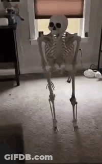 A Skeleton Is Standing In A Room Next To A Window . GIF