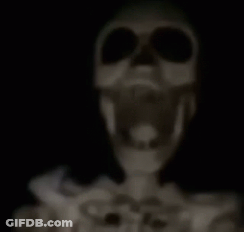 A Skeleton Is Standing In The Dark With A Stick In Its Mouth . GIF