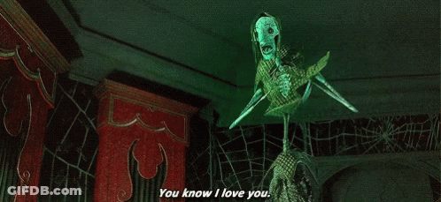 A Skeleton With A Green Mask Is Saying `` You Know I Love You '' In A Dark Room . GIF