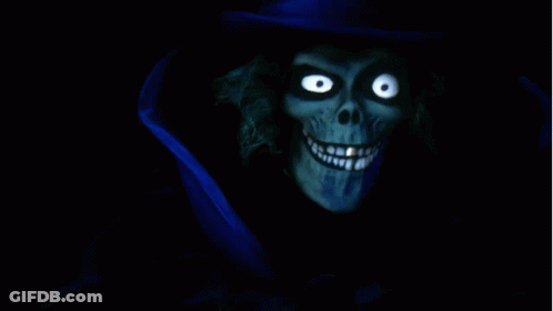 A Skeleton With Glowing Eyes And A Blue Top Hat GIF