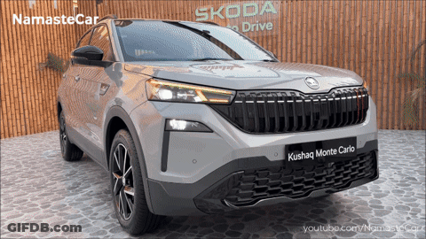A Skoda Car Is Displayed In Front Of A Wooden Wall GIF