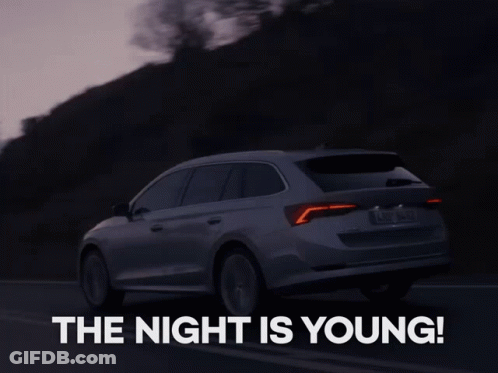 A Skoda Car Is Driving Down A Road At Night GIF
