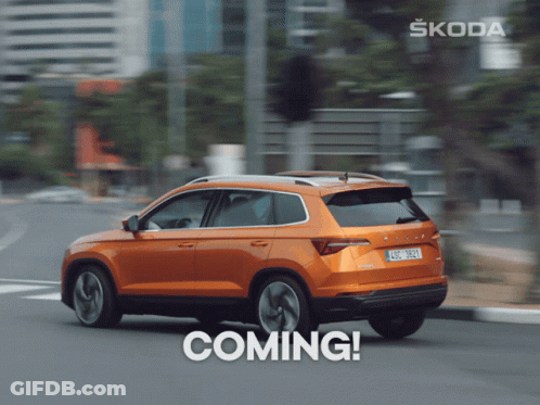 A Skoda Car Is Driving Down A Street With The Word Coming Below It GIF