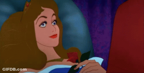 A Sleeping Beauty From Sleeping Beauty Is Holding A Rose In Her Hand . GIF