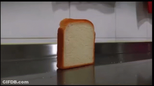 A Slice Of Bread Is Sitting On A Counter In A Kitchen . GIF
