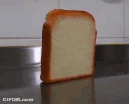 A Slice Of Bread Is Sitting On A Counter Top . GIF