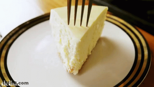 A Slice Of Cheesecake On A Plate With The Word Delish On The Bottom Right GIF