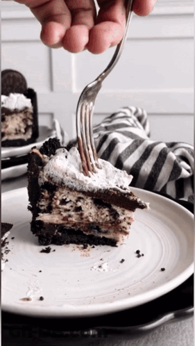 A Slice Of Oreo Pie On A White Plate With A Fork GIF
