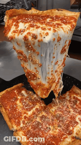 A Slice Of Pizza Is Being Taken Out Of The Pizza GIF