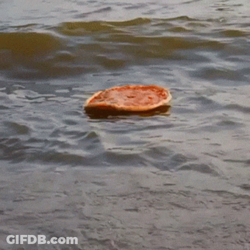 A Slice Of Pizza Is Floating In The Ocean GIF