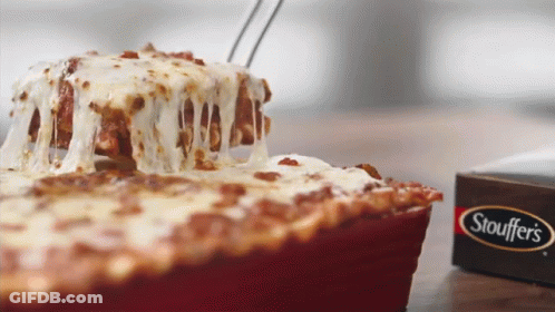A Slice Of Stouffer Lasagna Is Being Taken Out Of A Pan GIF