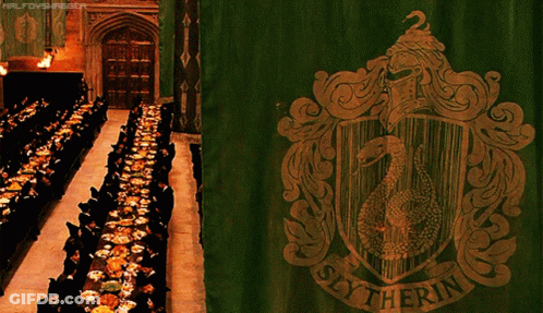 A Slytherin Banner Hangs In Front Of A Long Dining Room GIF