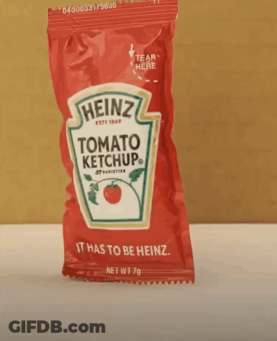 A Small Bag Of Heinz Tomato Ketchup Is Sitting On A Table GIF