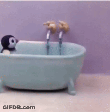 A Small Bathtub With Two Faucets And A Person In It . GIF