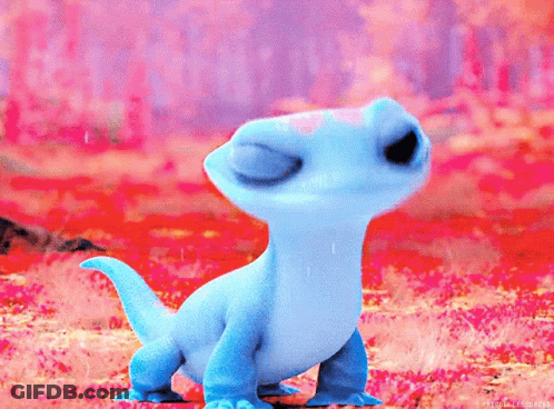 A Small Blue Lizard From Frozen Is Standing In A Field Of Flowers . GIF