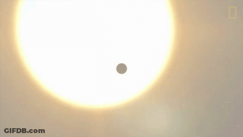 A Small Planet Is Moving In Front Of A Large White Star GIF