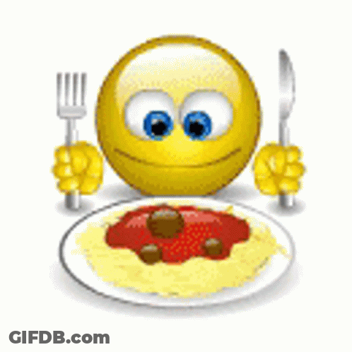 A Smiley Face Is Holding A Fork And Knife In Front Of A Plate Of Spaghetti And Meatballs . GIF