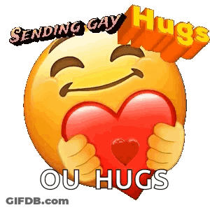 A Smiley Face Is Holding A Red Heart In Its Hands . GIF