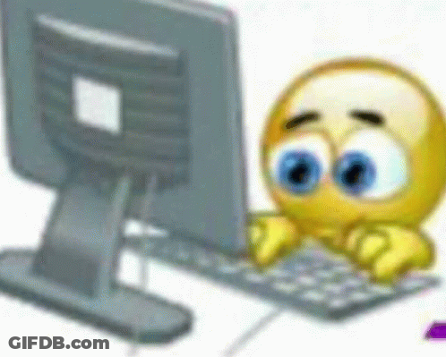 A Smiley Face Is Typing On A Keyboard In Front Of A Computer . GIF