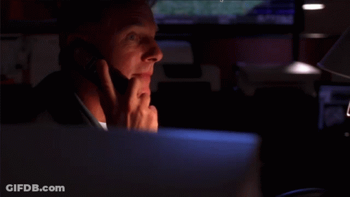 A Smiling Man Is Talking On A Cell Phone GIF