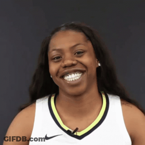 A Smiling Woman Wearing A White Nike Shirt GIF