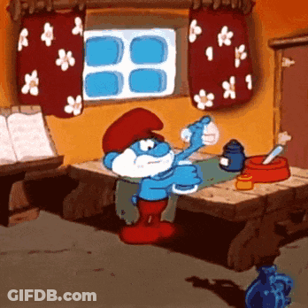 A Smurf Is Sitting At A Table Drinking Water GIF