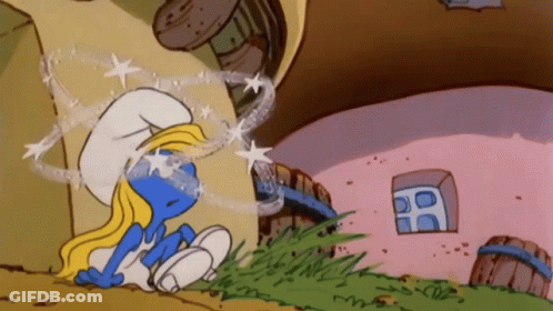 A Smurf Is Sitting In Front Of A Pink Building GIF
