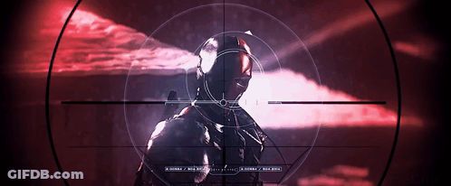 A Sniper Rifle Is Pointed At A Man In A Red Background GIF