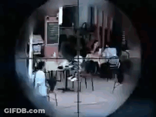 A Sniper 'S Scope Shows A Group Of People Sitting At Tables In A Restaurant . GIF