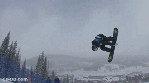 A Snowboarder Is Doing A Trick In The Air While Wearing A Blue And Yellow Shirt That Says ' A ' On It GIF