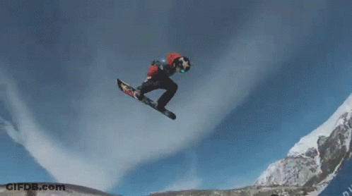 A Snowboarder Is Doing A Trick In The Air While Wearing A Red And White Jacket GIF