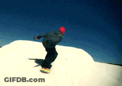 A Snowboarder Is Doing A Trick On Top Of A Snow Covered Hill GIF