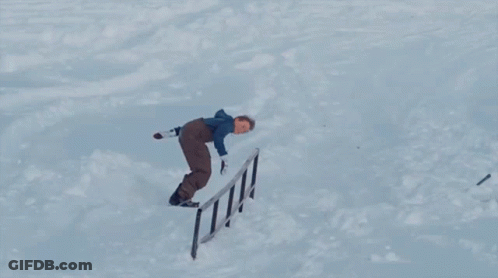 A Snowboarder Is Doing A Trick With The Word Burton On The Board GIF