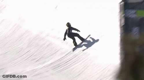 A Snowboarder Is Falling Off A Ramp In The Snow GIF