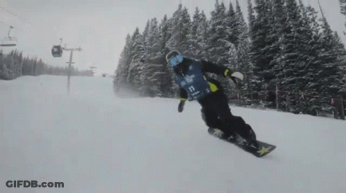 A Snowboarder Is Wearing A Blue And Yellow Shirt With The Number 11 On It GIF