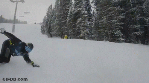 A Snowboarder Wearing A Blue Shirt With The Number 17 On It Is Going Down A Snow Covered Slope GIF
