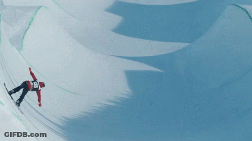 A Snowboarder Wearing A Red And White Jacket With The Number 25 On The Back GIF