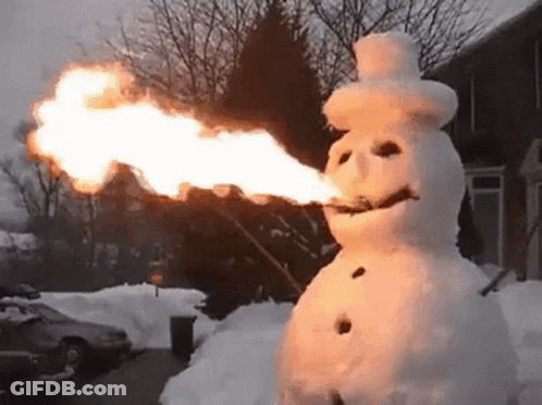A Snowman Is Holding A Torch In His Mouth . GIF