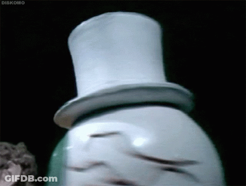 A Snowman Wearing A Top Hat Is Standing In A Dark Room . GIF