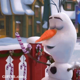 A Snowman With A Carrot In His Mouth Is Holding A Candy Cane . GIF