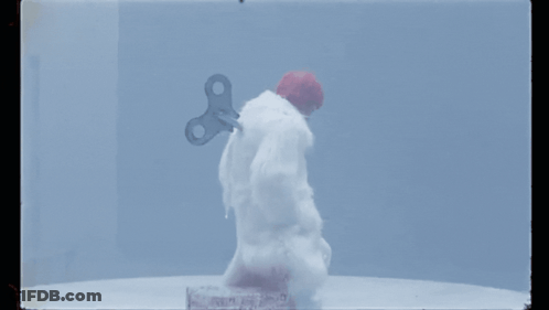 A Snowman With A Wind Up Key On His Back GIF